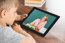 boy on tablet with teacher